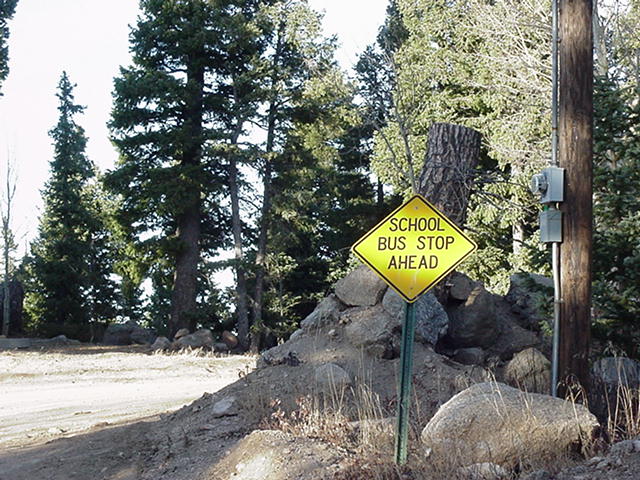 Mountain backroad bus stop sign